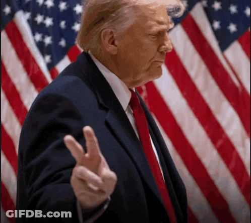 Donald Trump Giving A Peace Sign In Front Of The American Flag GIF