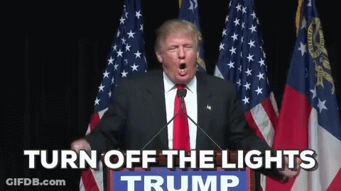 Donald Trump Is Giving A Speech In Front Of American Flags And Says " Turn Off The Lights " GIF