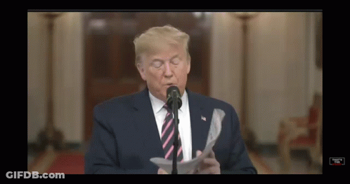 Donald Trump Is Speaking Into A Microphone While Reading A Piece Of Paper GIF