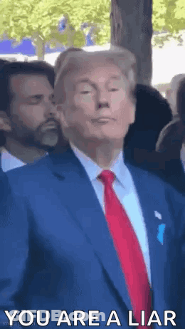 Donald Trump Is Wearing A Blue Suit And Red Tie And Is Standing In Front Of A Crowd . GIF