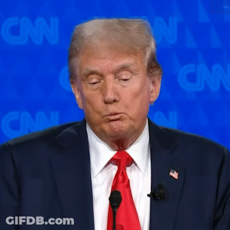 Donald Trump Is Wearing A Suit And Tie And Is Speaking Into A Microphone GIF