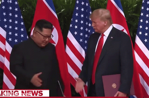 Donald Trump Shakes Hands With Kim Jong Un In Front Of American And North Korean Flags GIF