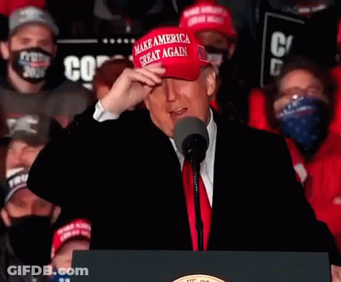 Donald Trump Wearing Make America Great Again Hat At Podium GIF
