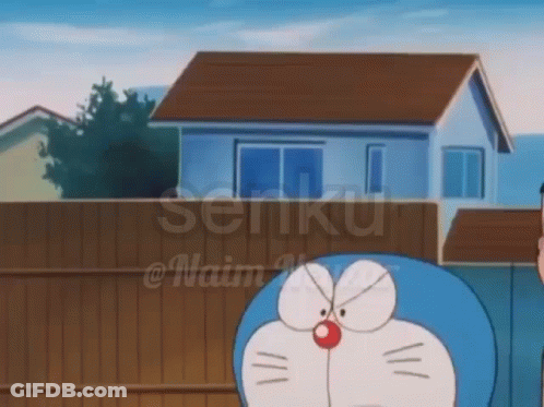 Doraemon In Front Of House With Fence GIF