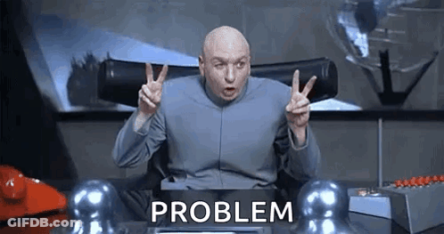 Dr. Evil Is Giving A Peace Sign While Sitting At A Desk With The Word Problem Behind Him . GIF