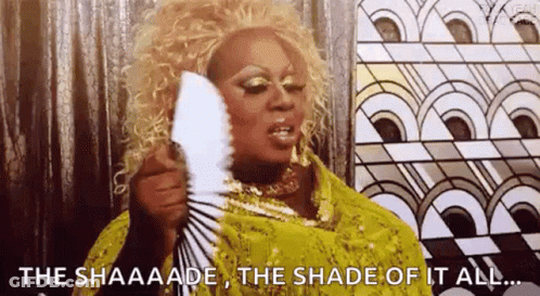 Drag Queen Holding Fan Saying The Shaaaade GIF