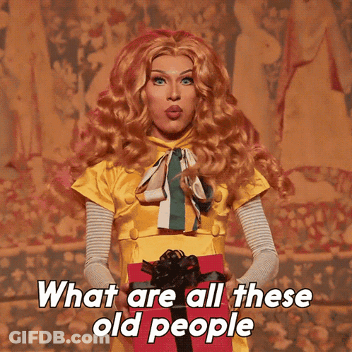 Drag Queen Holding Gift Box Saying What Are All These Old People GIF
