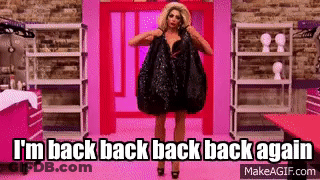 Drag Queen In Black Dress Holding Bag Against Pink Wall GIF