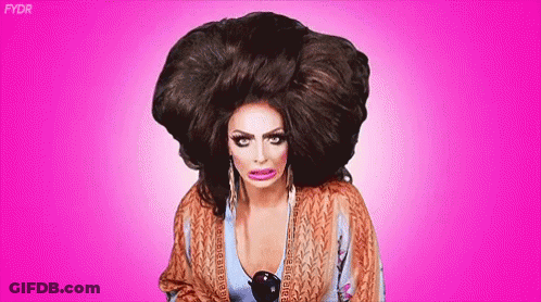 Drag Queen In Large Wig Making Funny Face GIF