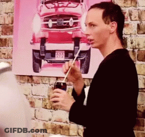 Drag Queen In Large Wig Making Funny Face GIF