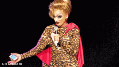 Drag Queen In Leopard Print Dress Holding Microphone GIF