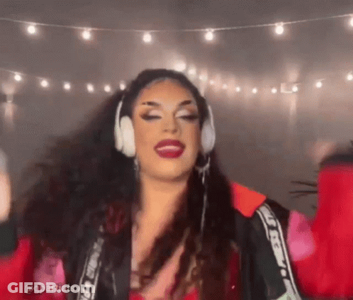Drag Queen With Headphones And Red Jacket Dancing GIF