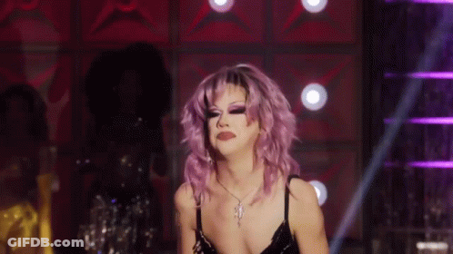 Drag Queen With Purple Hair Dancing On Stage GIF