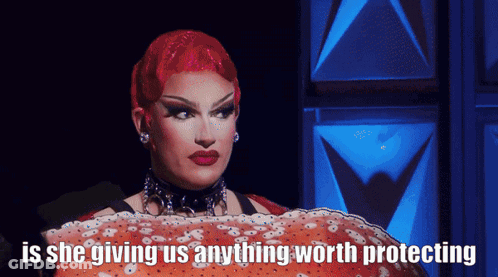 Drag Queen With Red Hair Holding Large Crab Saying Is She Giving Us Anything Worth Protecting GIF