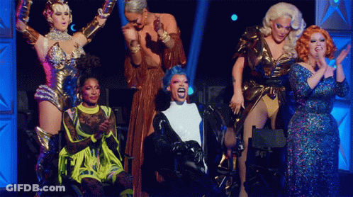 Drag Queens On Stage One With Blue Wig GIF