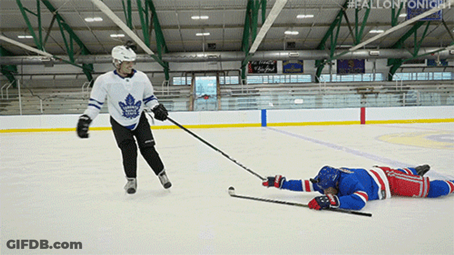 Dragging Another Player On Hockey Field GIF