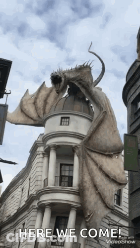 Dragon Statue Flying Over Building GIF