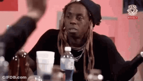 Dreadlocked Man At Table With Water And Cups GIF