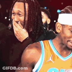 Dreadlocked Man Covering Mouth, Another Laughs GIF