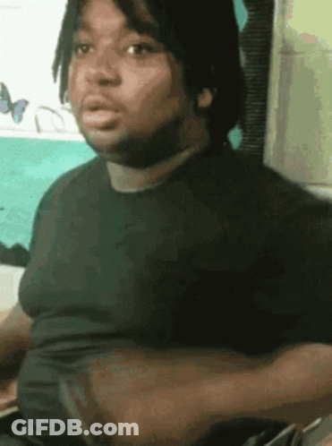 Dreadlocked Man In Black Shirt Making Funny Face GIF
