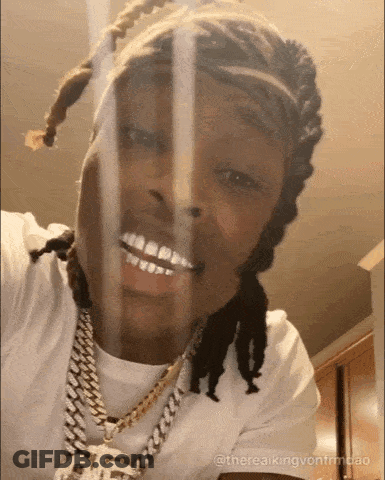 Dreadlocked Man In White Shirt Smiling At Camera GIF