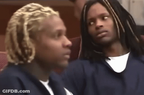 Dreadlocked Man Next To Man In Chair GIF