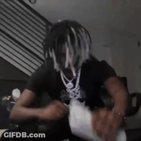 Dreadlocked Man Sitting On Couch Holding Money Bag GIF