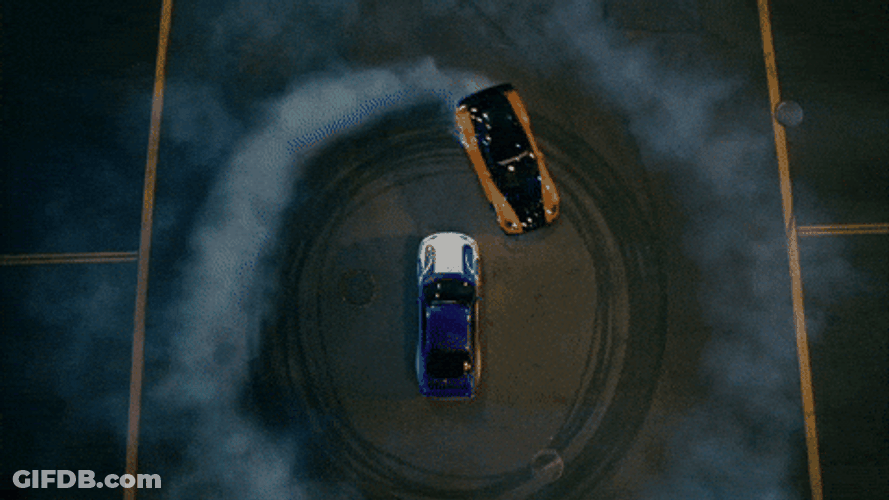 Drift Cars Creating Donuts Around A Car GIF