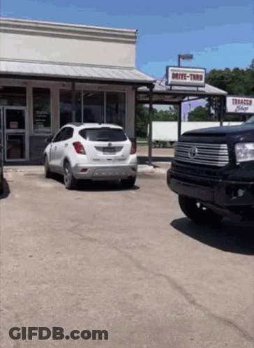 Drive-Thru Tobacco Shop With White SUV GIF
