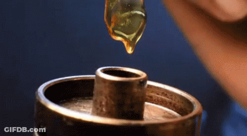 Drop Of Liquid Being Poured Into Metal Object GIF