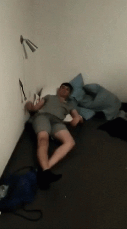 Drunk Guy Clapping While On Bed GIF