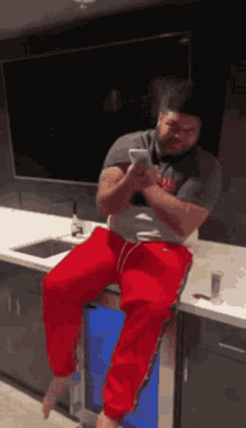 Druski Sitting And Holding Phone GIF