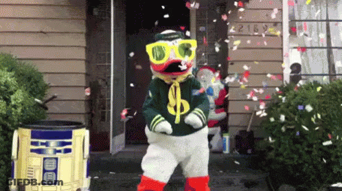 Duck Mascot Dancing With Falling Confetti GIF