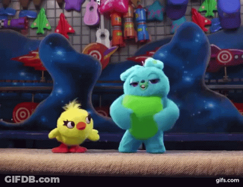 Ducky And Bunny From Toy Story Are Standing Next To Each Other On A Stage . GIF