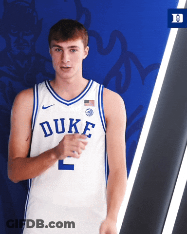 Duke Basketball Player In Front Of Blue Wall GIF