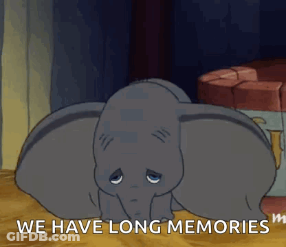 Dumbo From The Disney Movie Dumbo Is Laying Down On The Floor With His Eyes Closed . GIF
