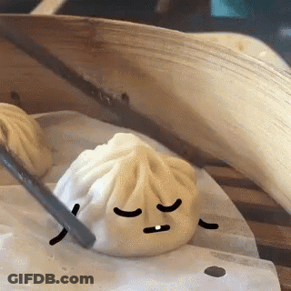 Dumpling With Face Being Eaten By Chopstick GIF