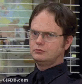 Dwight Schrute Is Wearing Glasses And A Black Shirt And Tie . GIF
