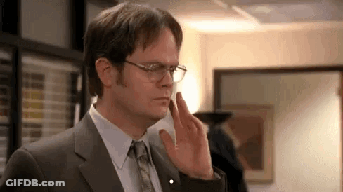 Dwight Schrute Is Wearing Glasses And A Suit And Tie . GIF