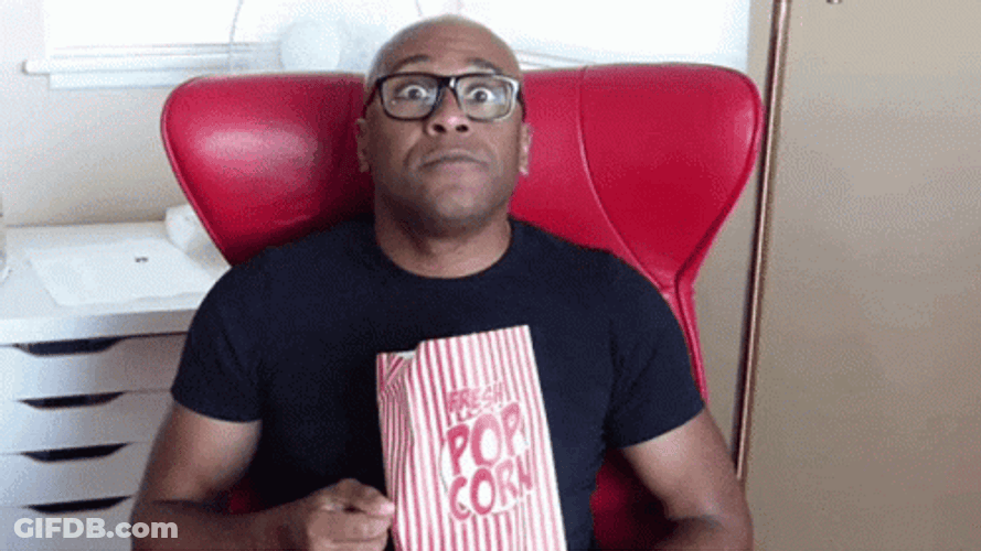 Edge Of My Seat Eating Popcorn GIF