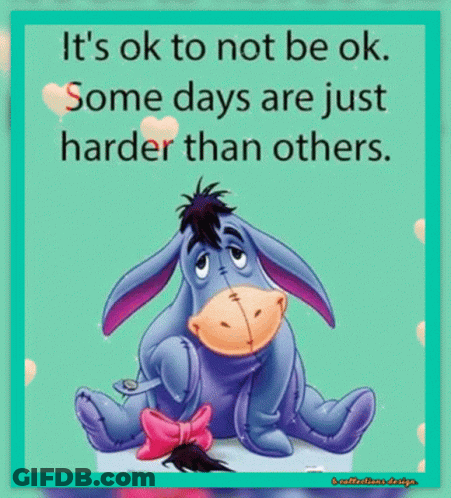 Eeyore From Winnie The Pooh Is Sitting Down With A Pink Bow On His Tail GIF