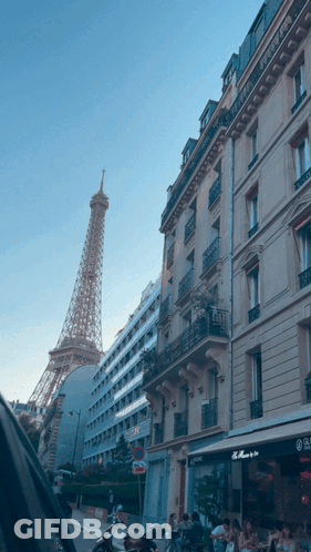 Eiffel Tower Behind Building With No Parking Sign GIF
