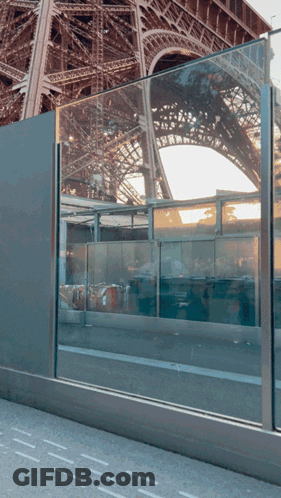 Eiffel Tower Reflected In Glass Barrier GIF
