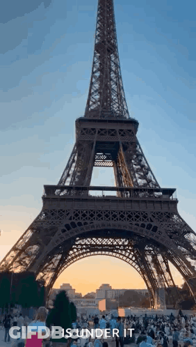 Eiffel Tower Under Construction With Crowd GIF