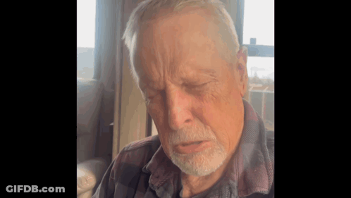 Elderly Bearded Man Sitting By Window GIF