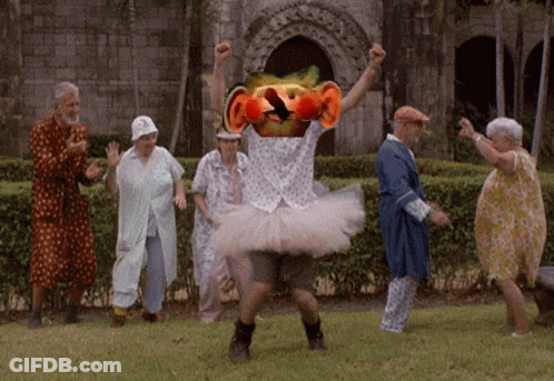Elderly Dancing In Park With Man In Tutu GIF