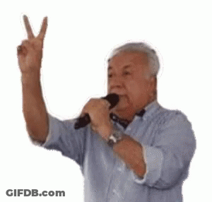 Elderly Man Holding Microphone Giving Peace Sign GIF