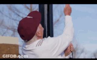 Elderly Man In Maroon Hat Hanging Light Pole GIF