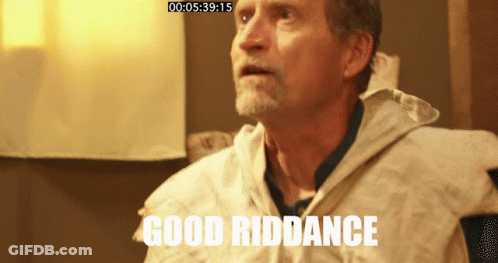 Elderly Man In Striped Apron Looking At Camera GIF