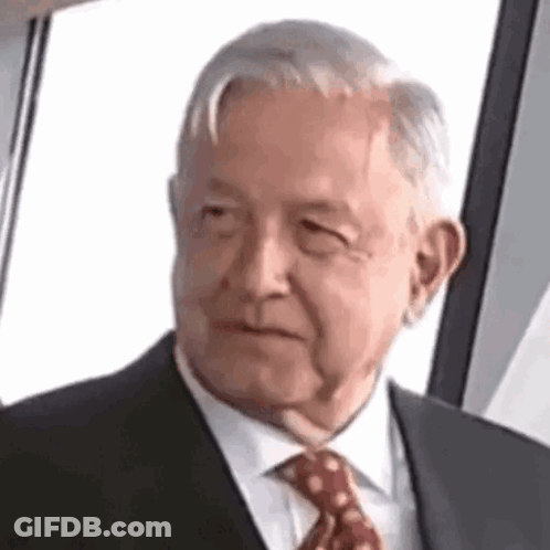Elderly Man In Suit And Tie Looking At Camera GIF